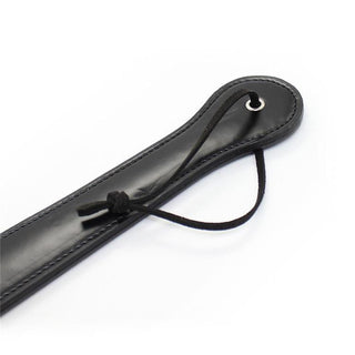 An image showcasing the generous length and width of the No Frills Slapper Leather Sex Paddle for versatile impact play.