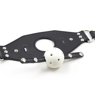 Observe an image of Studded Leather Gag Ball with 27.56 inches strap length for absolute control.
