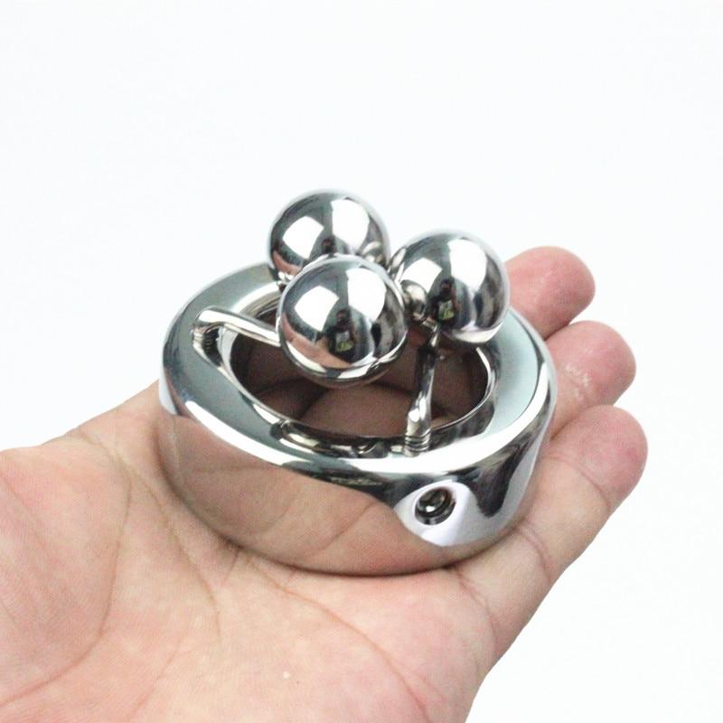 Metal ball stretcher with three weighted orbs for intense pleasure and torment.