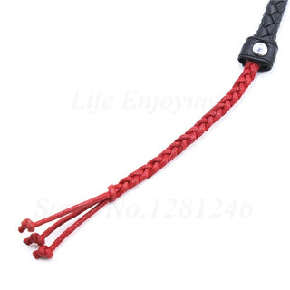 Total Obedience BDSM Leather Whip showcasing its elegance with a long handle and unique red leather strip tips.