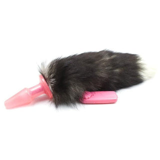 You are looking at an image of Vibrating Fox Tail Plug with pink plastic plug and black synthetic fur tail, designed for untamed pleasure.