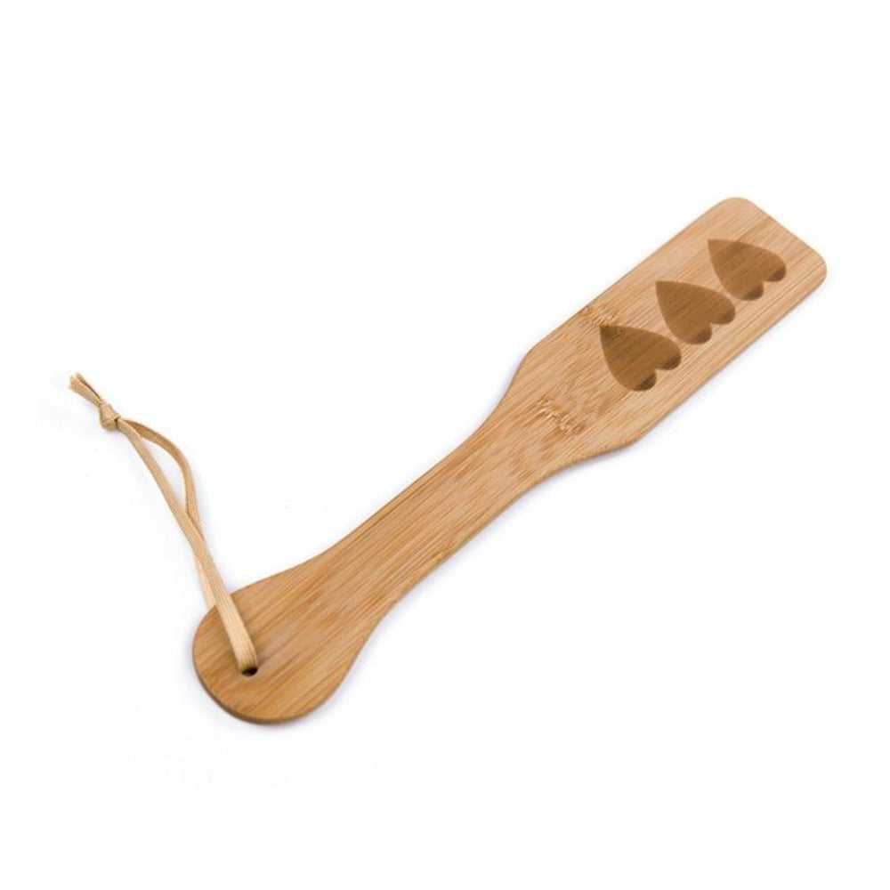 Wooden paddle with a cloth-like cord handle loop for a secure grip during passionate moments.
