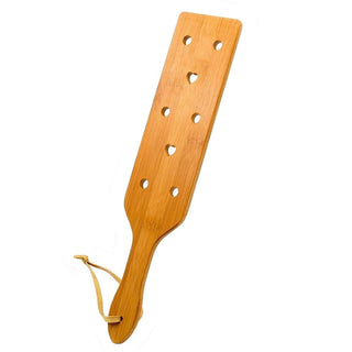 Take a look at an image of a uniquely crafted paddle with circular and heart-shaped holes for varied sensations.