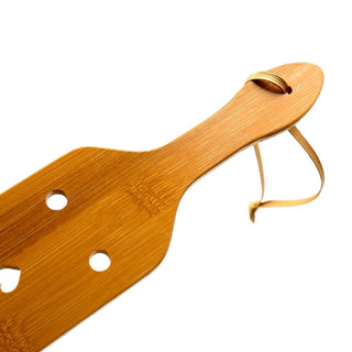 Featuring an image of a well-crafted BDSM paddle with a smooth surface and secure grip handle.