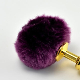 This is an image of Ribbed Golden Bunny Tail 5.7 Inches Long in magenta color for a playful touch.