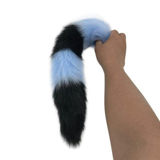 In the photograph, you can see an image of Mythical Blue Wolf Tail Plug 2.76 to 3.54 inches long in large size with metal plug and synthetic fur handle.